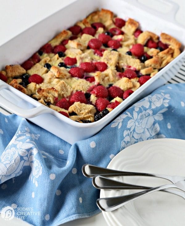 French Toast Casserole with berries in a white casserole dish.