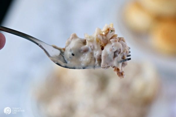 country sausage gravy and biscuits on a fork