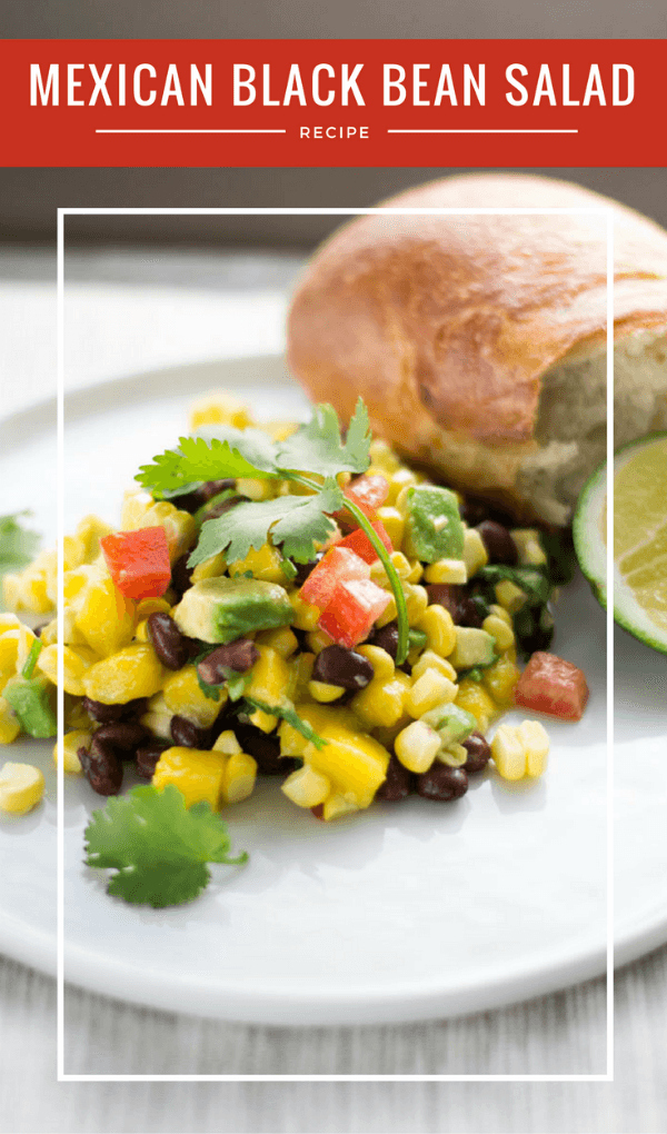 Mexican Black Bean and Corn Salad with a roll on a white plate