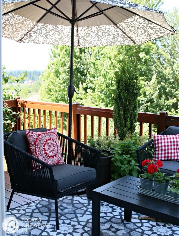 outdoor seating area with chairs and a big umbrella