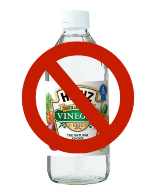 bottle of white vinegar with a "no" symbol through it