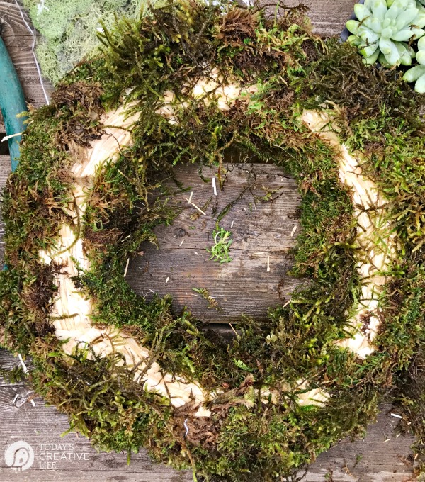 Filling in moss on a straw wreath