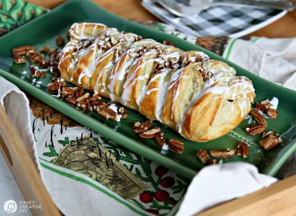 Pumpkin Cream Cheese Puff Pastry Braid on a green dessert platter