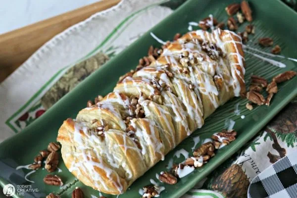 Pumpkin Cream Cheese Puff Pastry Braid topped with glaze and chopped pecans