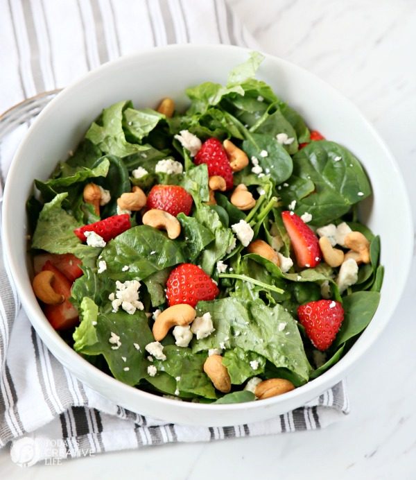 Strawberry Gorgonzola Salad with Cashews | Toped with homemade vinaigrette, loaded with spinach, romaine and Flavor! TodaysCreativeLife.com
