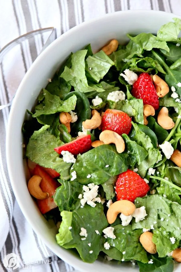 Strawberry Gorgonzola Salad with Cashews | Topped with homemade vinaigrette, loaded with spinach, romaine and Flavor!