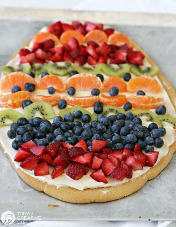 Sugar Cookie Easter Egg Fruit Pizza | Easy to make Easter treat. Cream Cheese frosting topped with your favorite fruits | Colorful Spring Dessert Ideas | TodaysCreativeLife.com