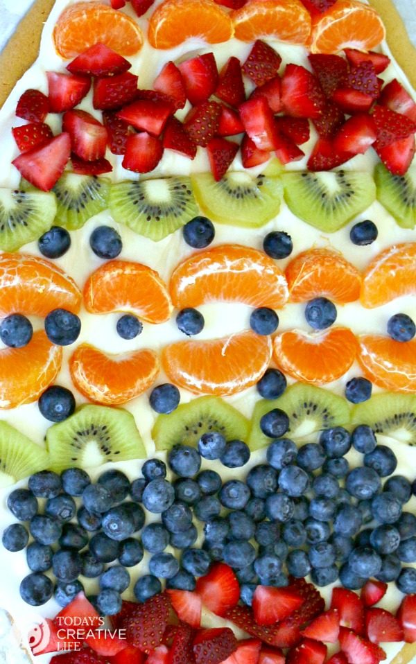 Sugar Cookie Easter Egg Fruit Pizza | Easy to make Easter treat. Cream Cheese frosting topped with your favorite fruits | Colorful Spring Dessert Ideas | TodaysCreativeLife.com