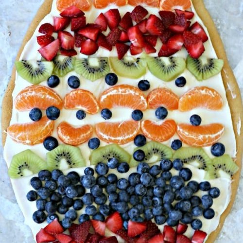 Sugar Cookie Easter Egg Fruit Pizza | Easy to make Easter treat. Cream Cheese frosting topped with your favorite fruits | Colorful Spring Dessert Ideas | TodaysCreativeLife.com
