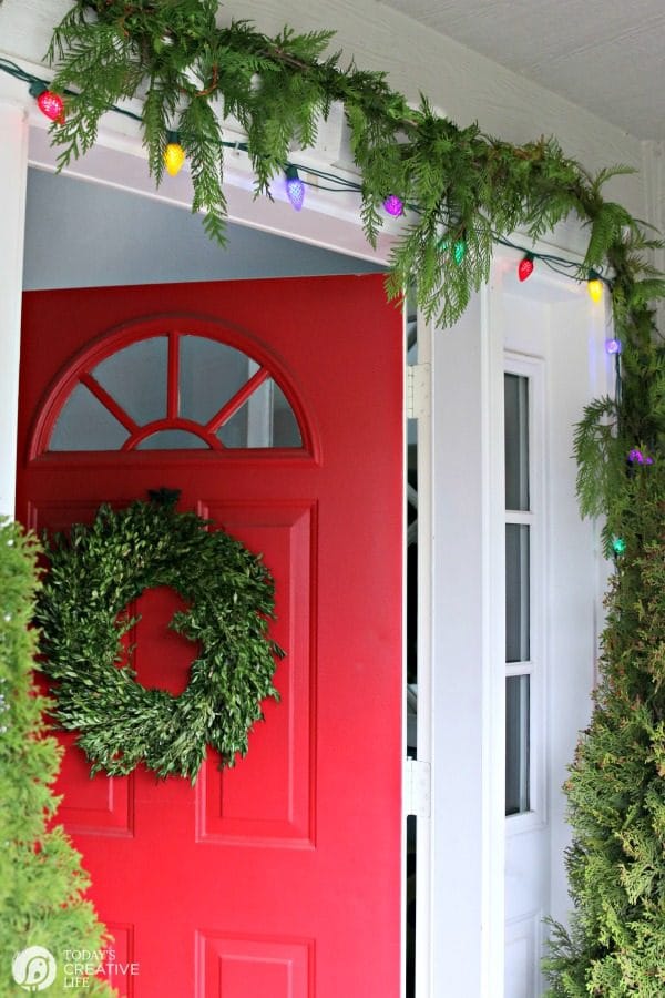 exterior of home decorated with cedar garland