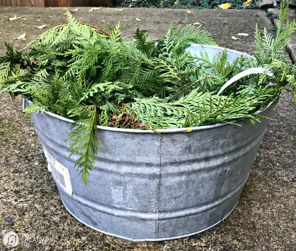 image shows how to keep garland fresh by soaking in a tub of water