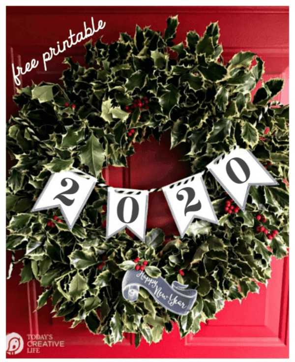 Holly wreath on red door with 2020 New years eve paper banner