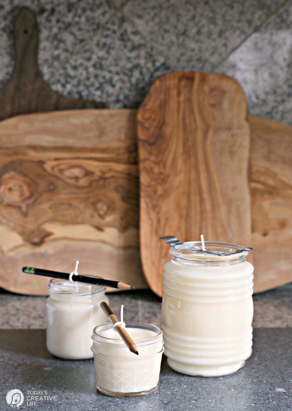 White candles in jars