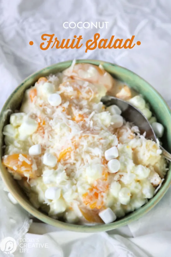 Coconut Fruit Salad Recipe with Marshmallows, Cream Cheese and Yogurt served in a green bowl. 