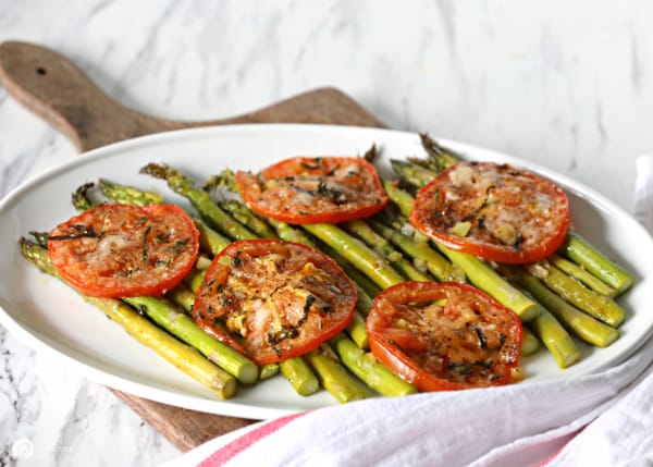 Roasted tomatoes and asparagus on serving platter