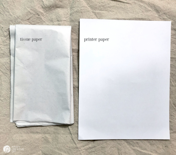 Tissue paper and printer paper set out for project