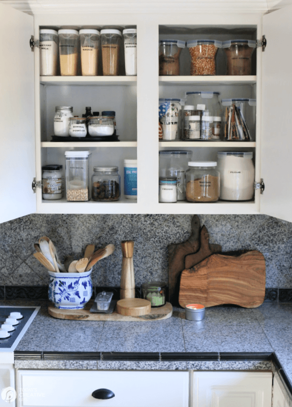 Open kitchen cabinets with food storage