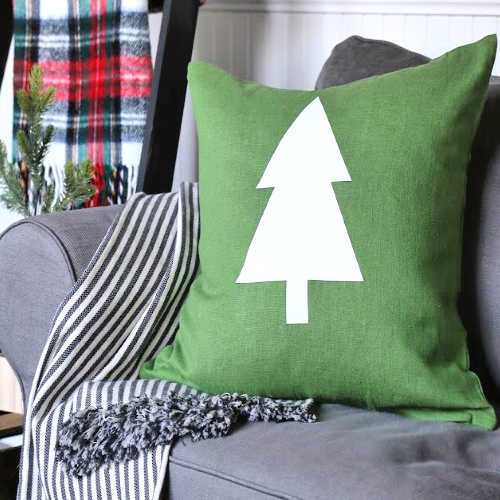 Green holiday pillow with white tree