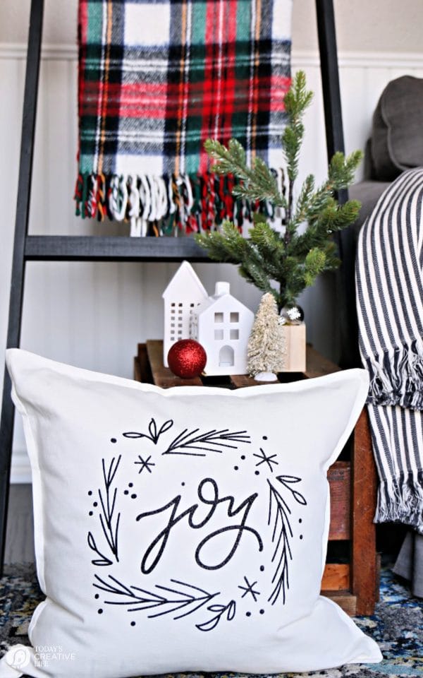 Christmas decorations with pillow, plaid blanket and nicknacks. 