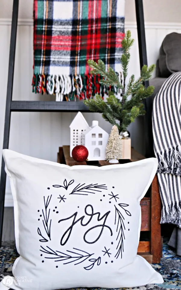 Christmas decorations with pillow, plaid blanket and nicknacks.