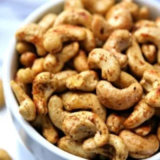 spicy cashews in white bowl.