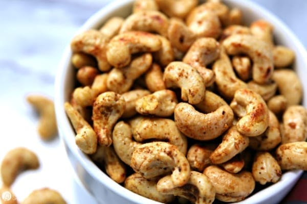 spicy cashews in white bowl.