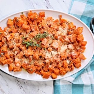 A large platter with cubed roasted sweet potatoes