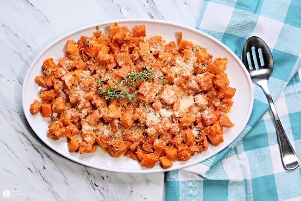 A large platter with cubed roasted sweet potatoes 