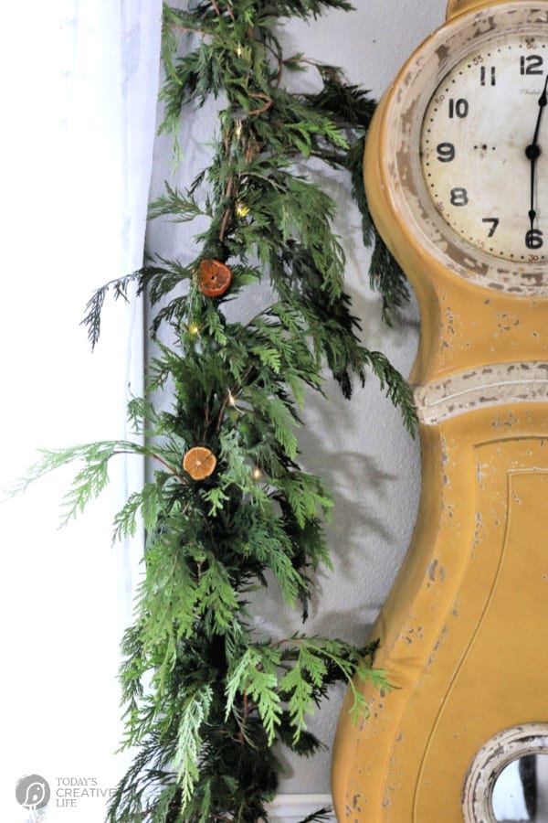 Gold Swedish Clock with Cedar Garland and Dried Oranges.