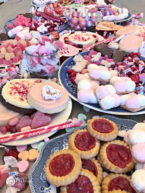 Pink and red cookies and candy on a table