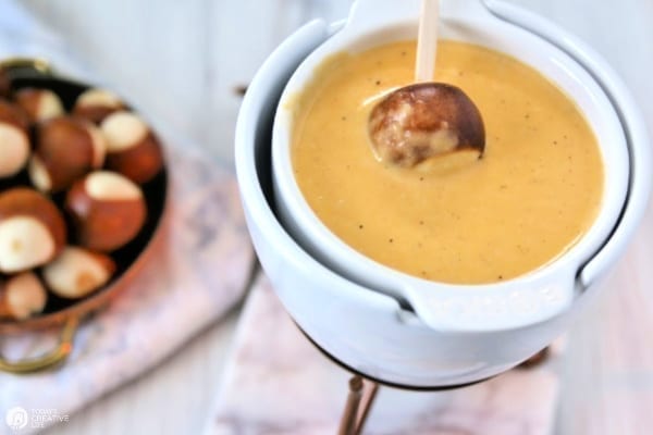 White fondue pot with cheese fondue