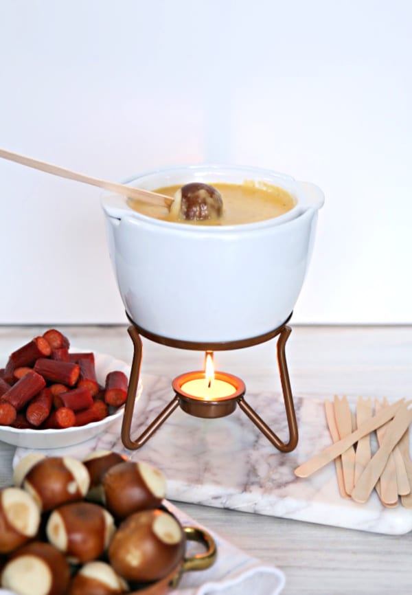 White fondue pot full of cheese fondue