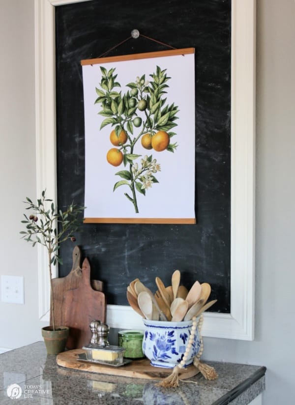 Kitchen chalk board with botanical poster.