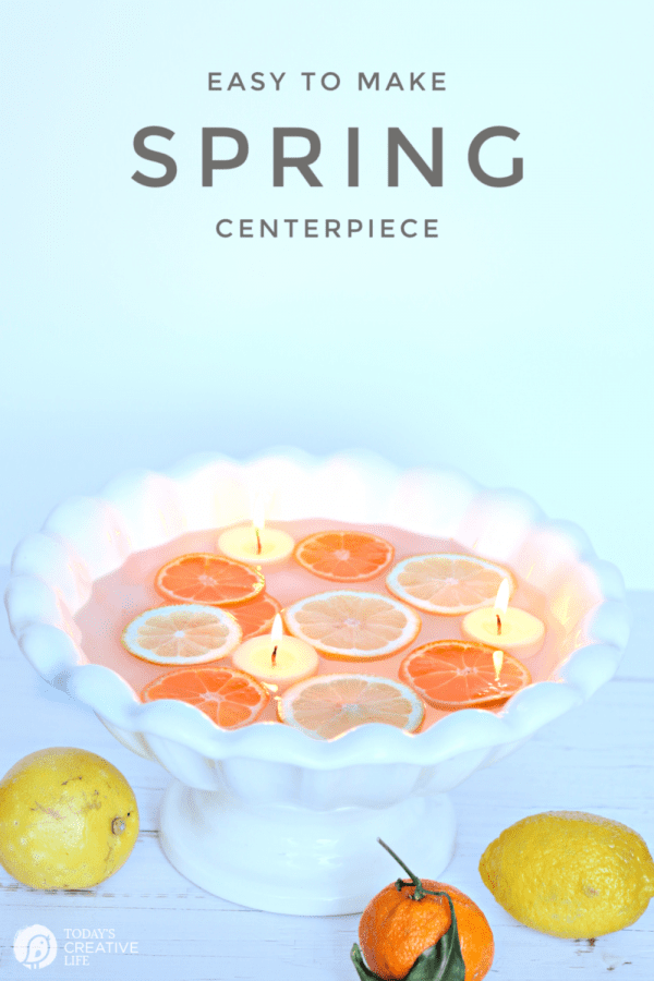 large bowl with water and floating sliced lemons with floating candles