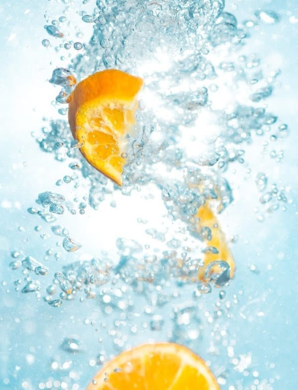 sliced oranges in water