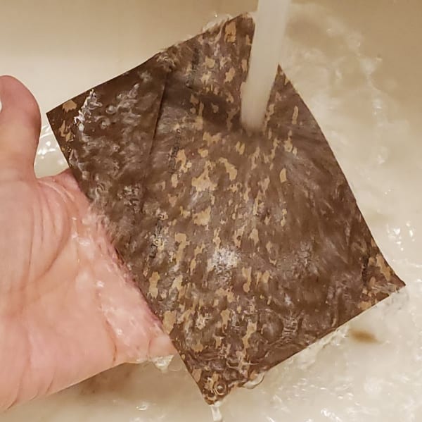 Water running over square cardboard