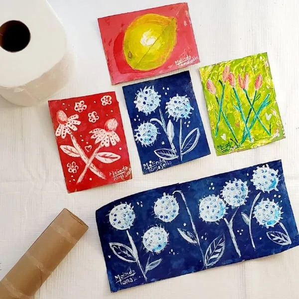 Flattened cardboard toilet paper rolls with painted art Painted Art on cardboard recycled from Toilet paper tubes