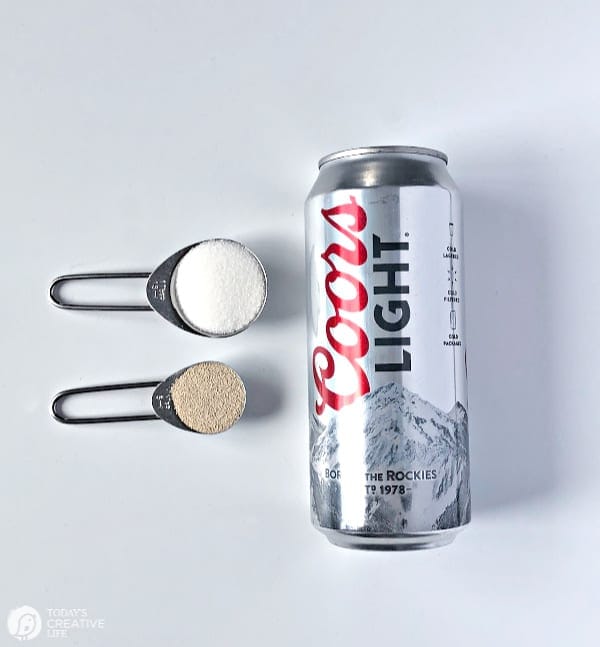 Can of Beer with sugar and yeast in measuring spoons