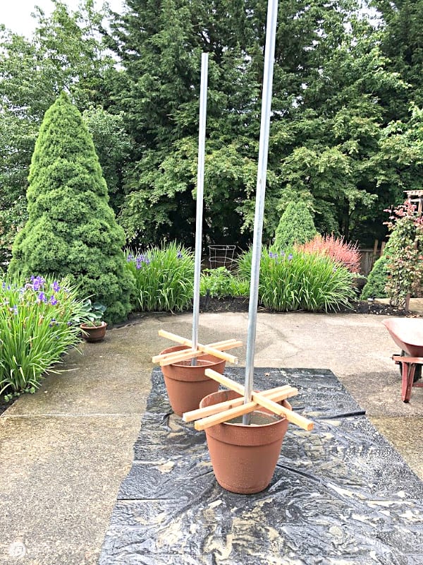 2 planters with poles for lights