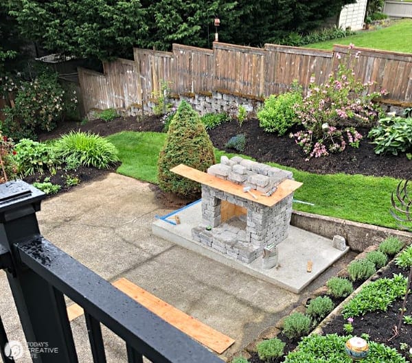 half finished building of an backyard stone fireplace