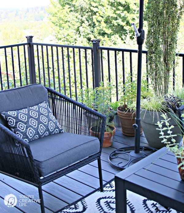 Grey patio furniture with deck railing in the background.