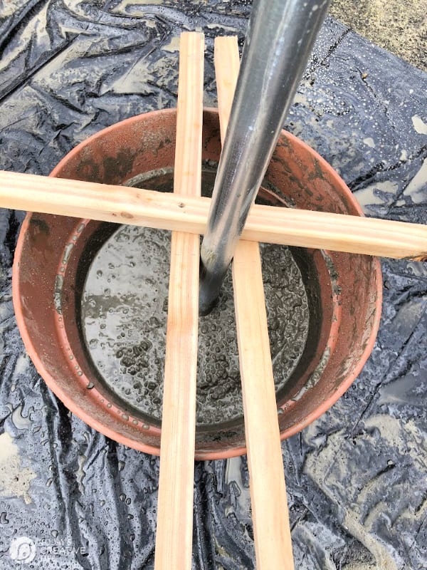 a planter with wet cement and wood braces