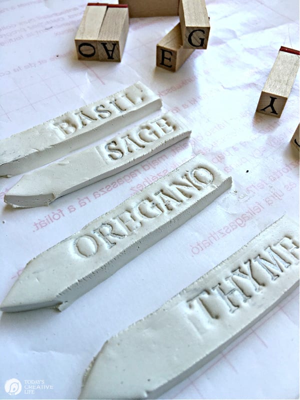 DIY Garden Plant Markers - White clay garden plant markers stamped with herb name.