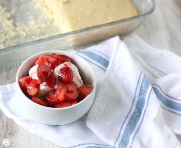 bowl of strawberries with a sheet cake