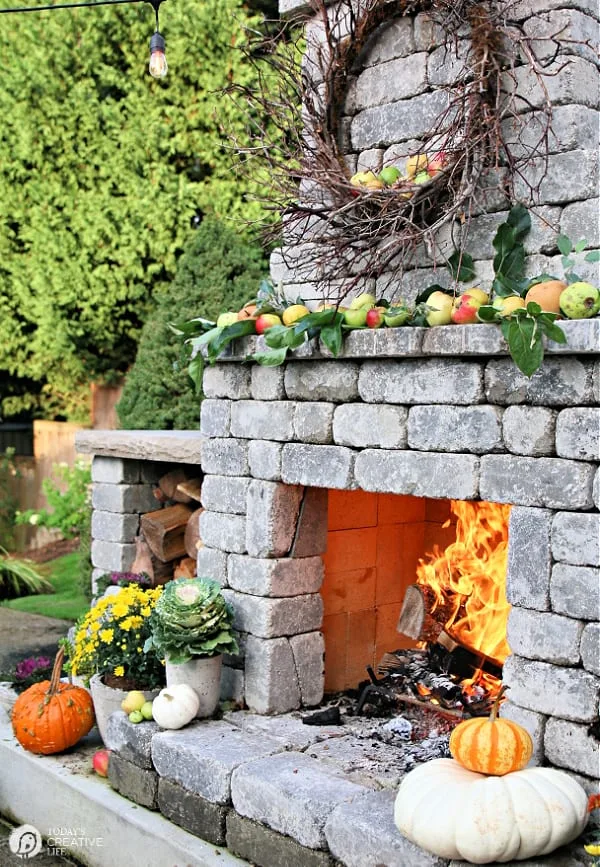 Outdoor stone fireplace decorated for Fall