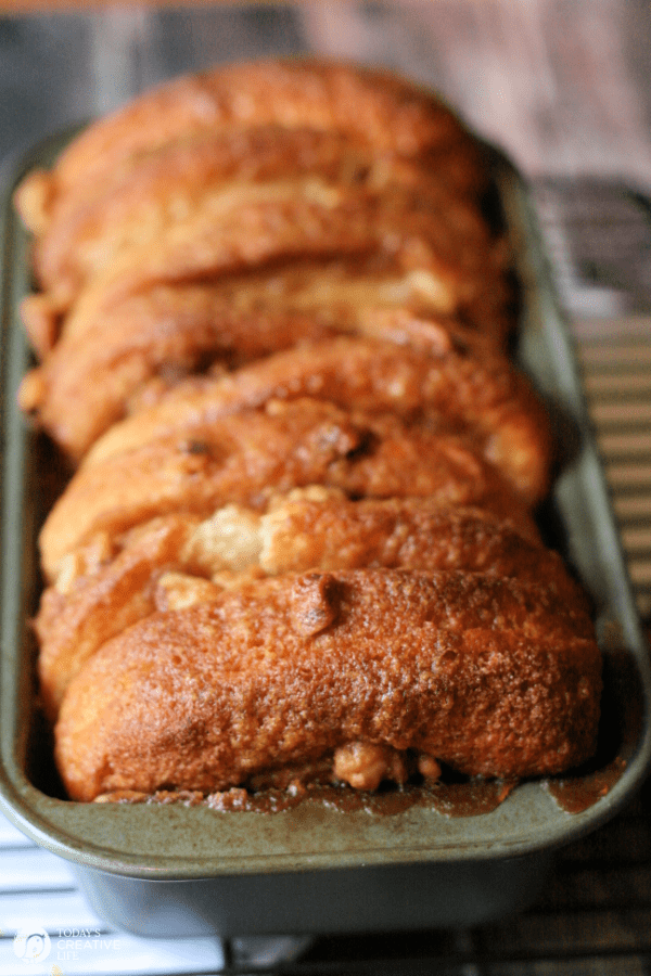 Browned loaf of breakfast of layered pull apart monkey bread. 