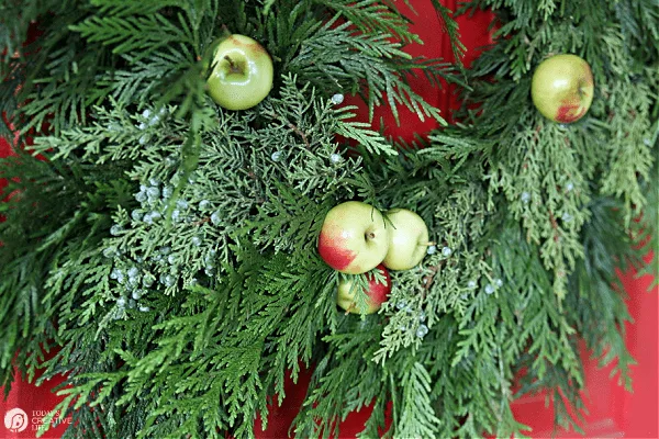 green cedar wreath with apples.