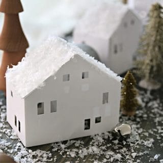 white paper house with faux snow on top.