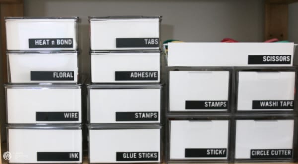 Craft Room Organization containers with black labels.