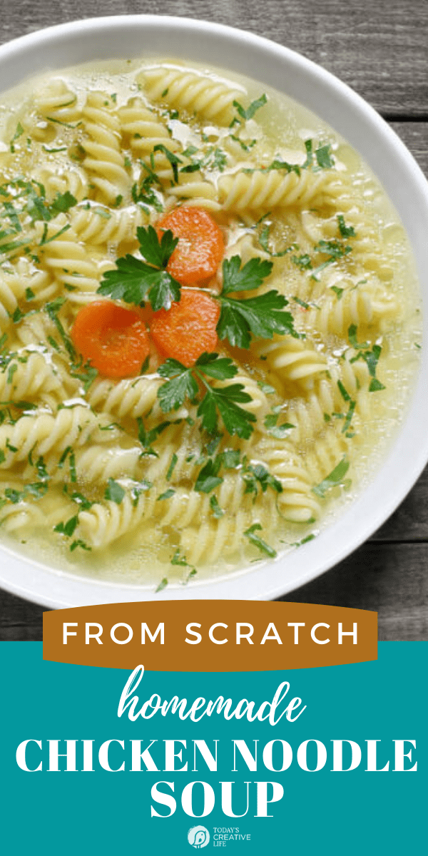 Homemade Chicken Noodle Soup from Scratch | White bowl filled with chicken soup with noodles, carrots and parsley.